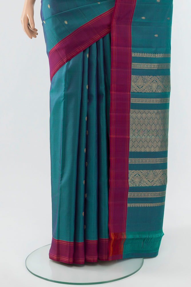 Pleats and pallu of Peacock Blue Kanchipuram Silk Saree with Zari Butta on the body and Silk Border. 