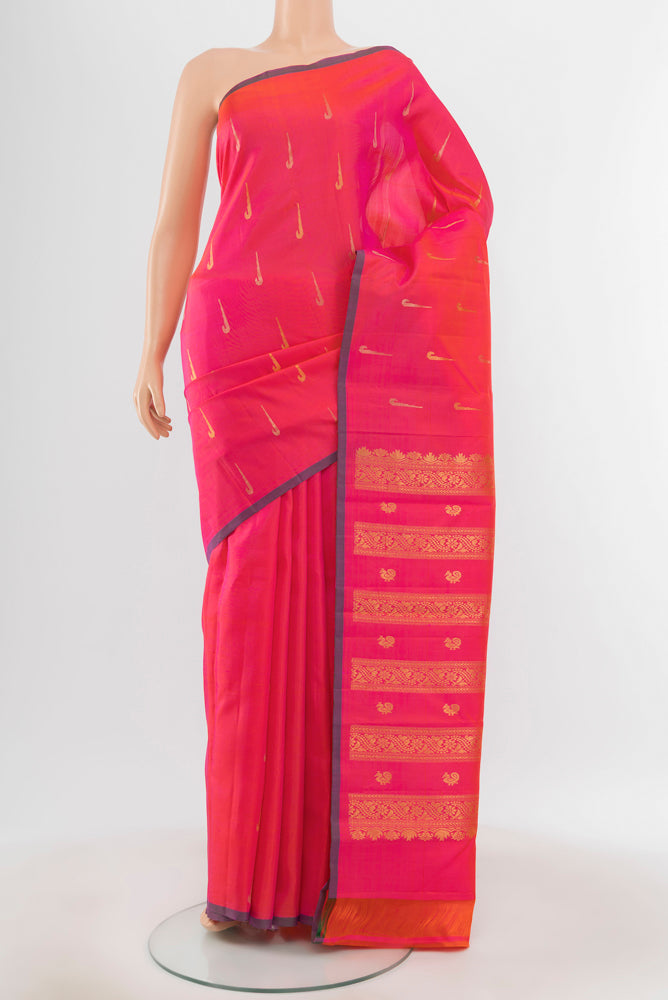 Pure Silk Pure Zari Peach Kanchipuram Saree with Zari Butta on the body and Silk Border.  displayed on a mannequin