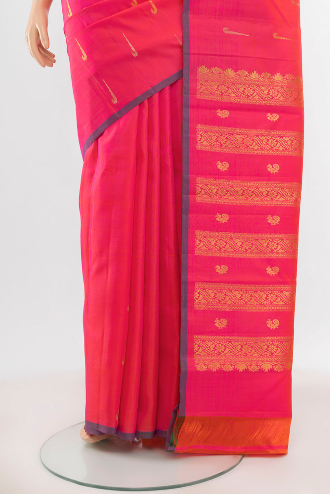 Pleats and pallu of Pure Silk Pure Zari Peach Kanchipuram Saree with Zari Butta on the body and Silk Border. 