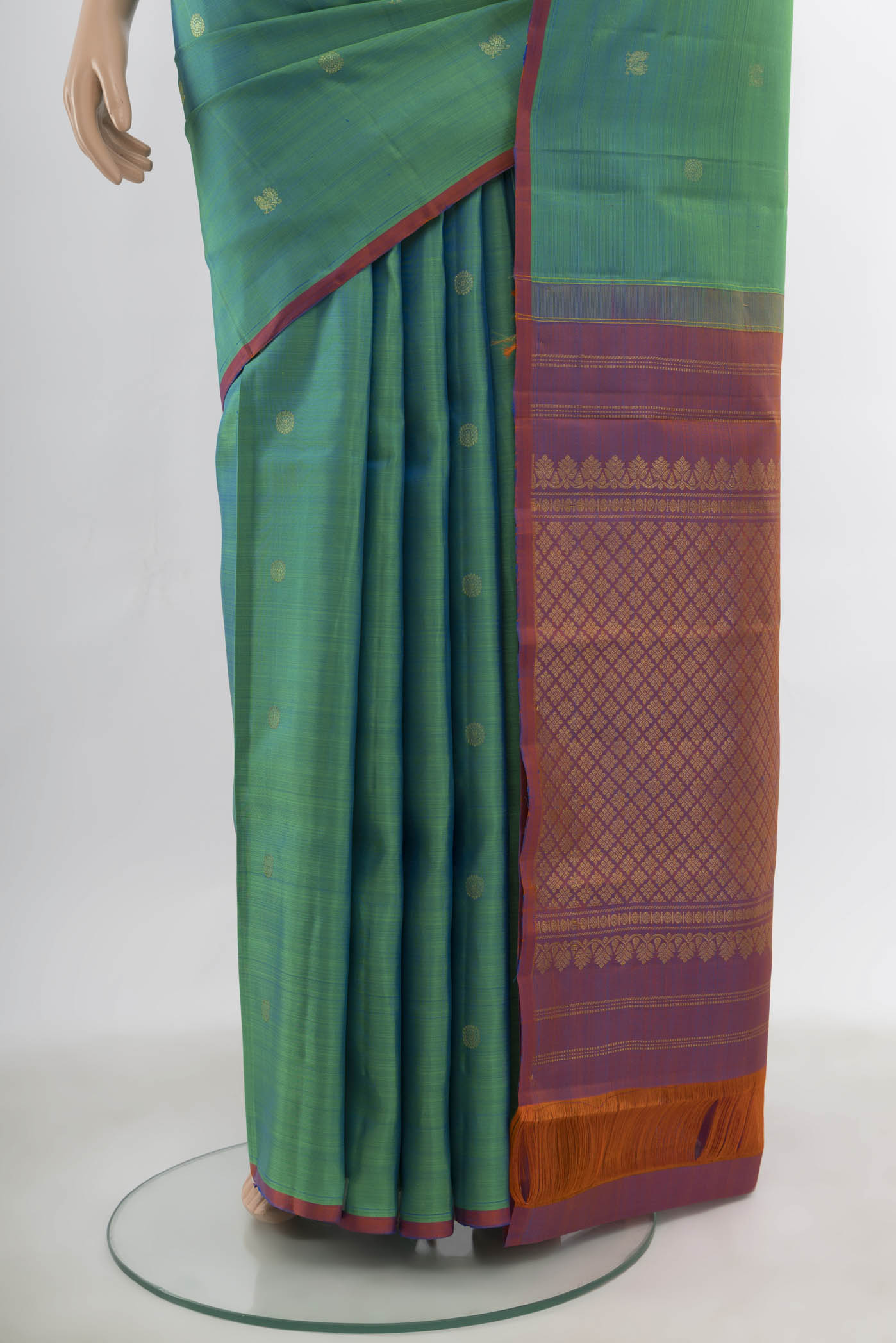 Pleats and pallu of Peacock Blue Kanchipuram Silk Saree with Zari Butta on the body and Silk Border. 