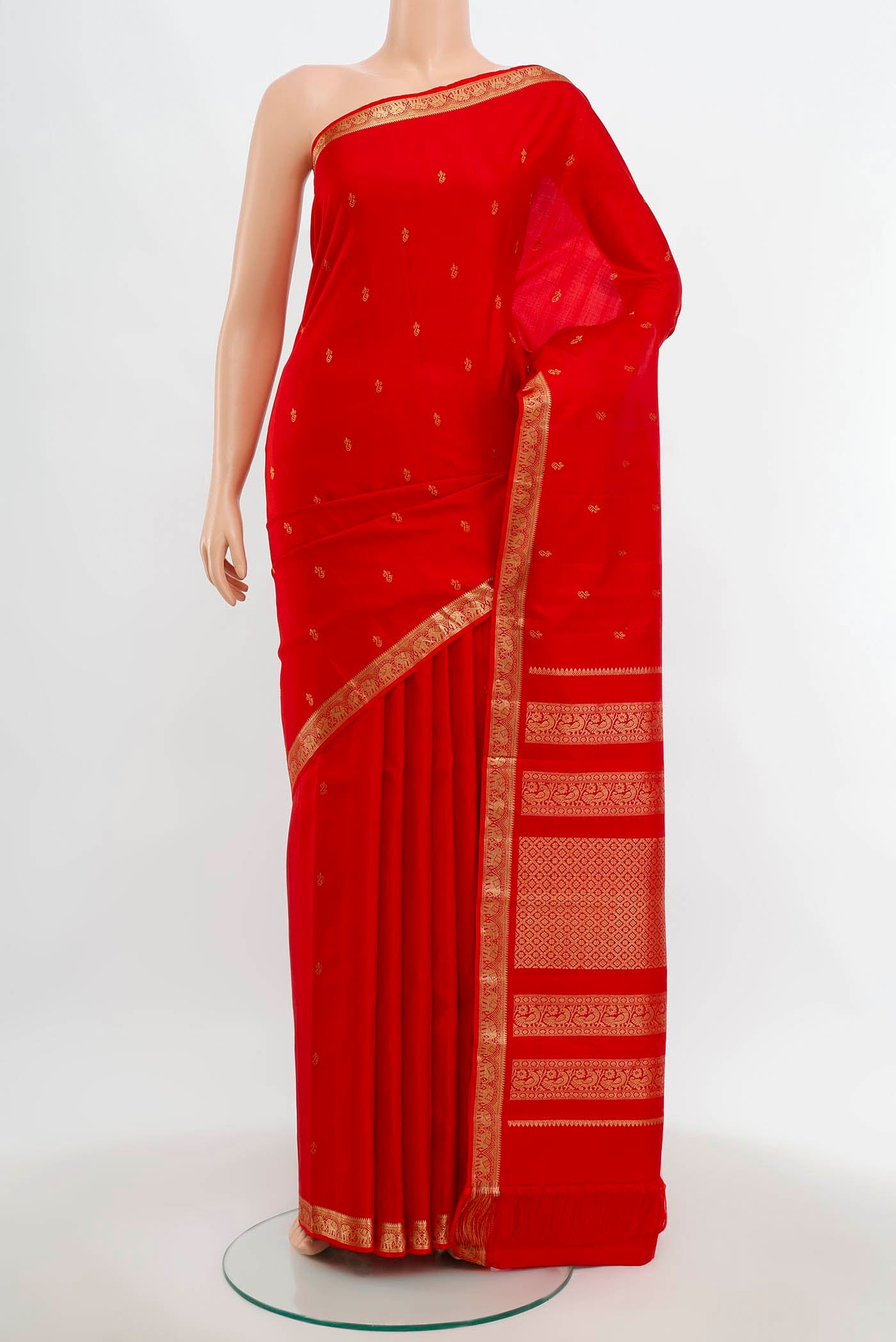 Red Kanchipuram Silk Saree with Zari Butta on the body and Silk Border.  displayed on a mannequin