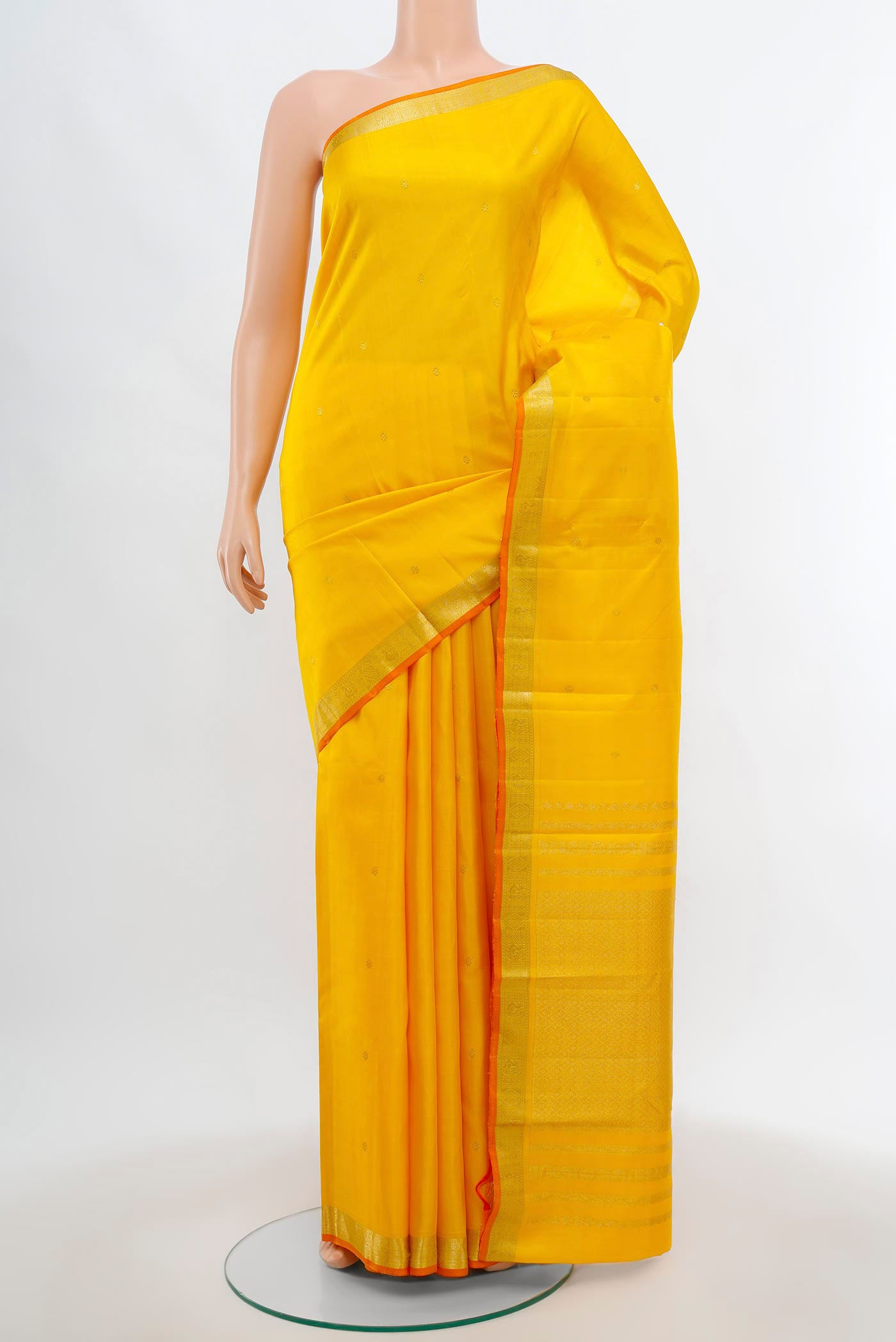 Yellow Kanchipuram Silk Saree with Zari Butta on the body and Silk Border.  displayed on a mannequin