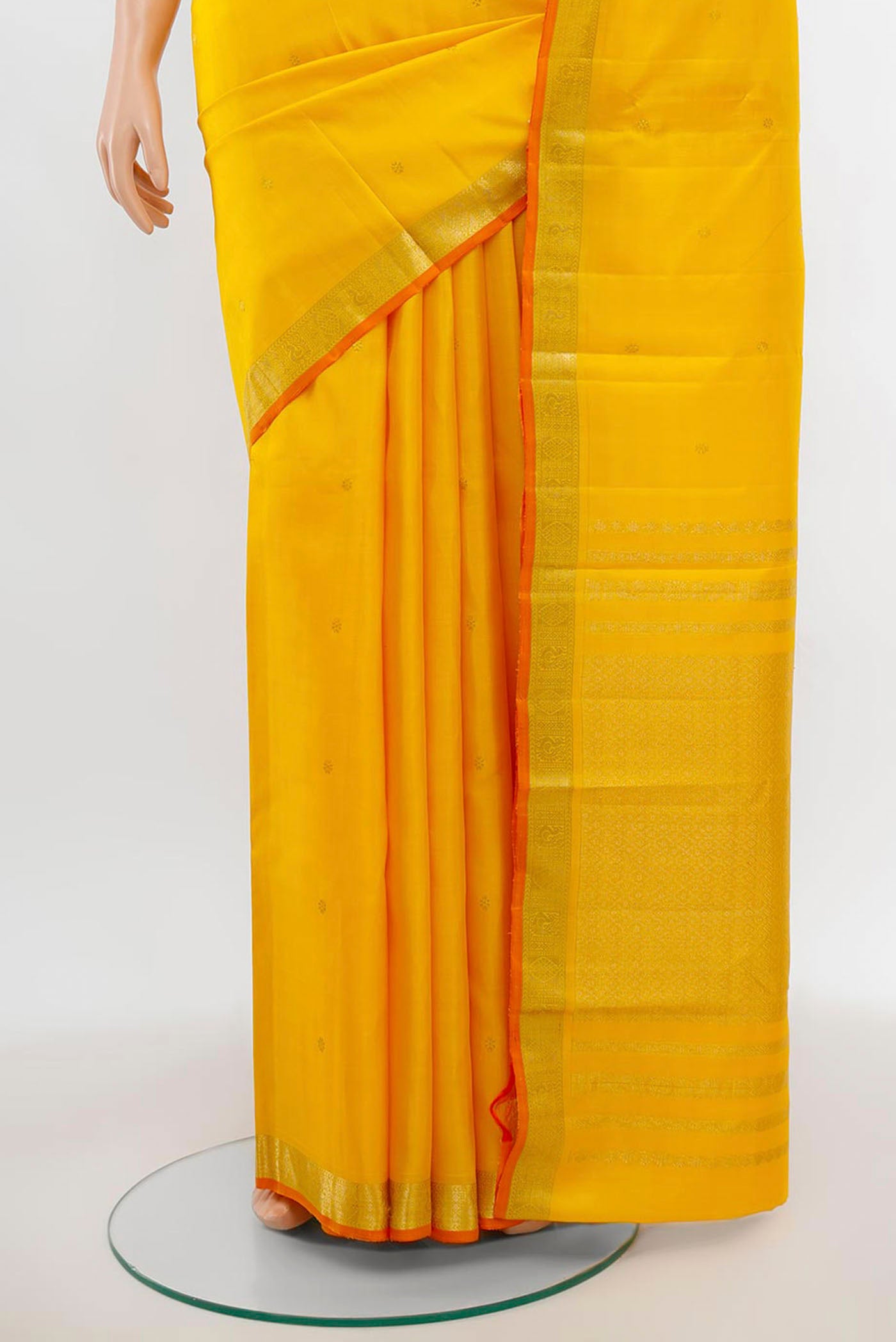 Pleats and pallu of Yellow Kanchipuram Silk Saree with Zari Butta on the body and Silk Border. 