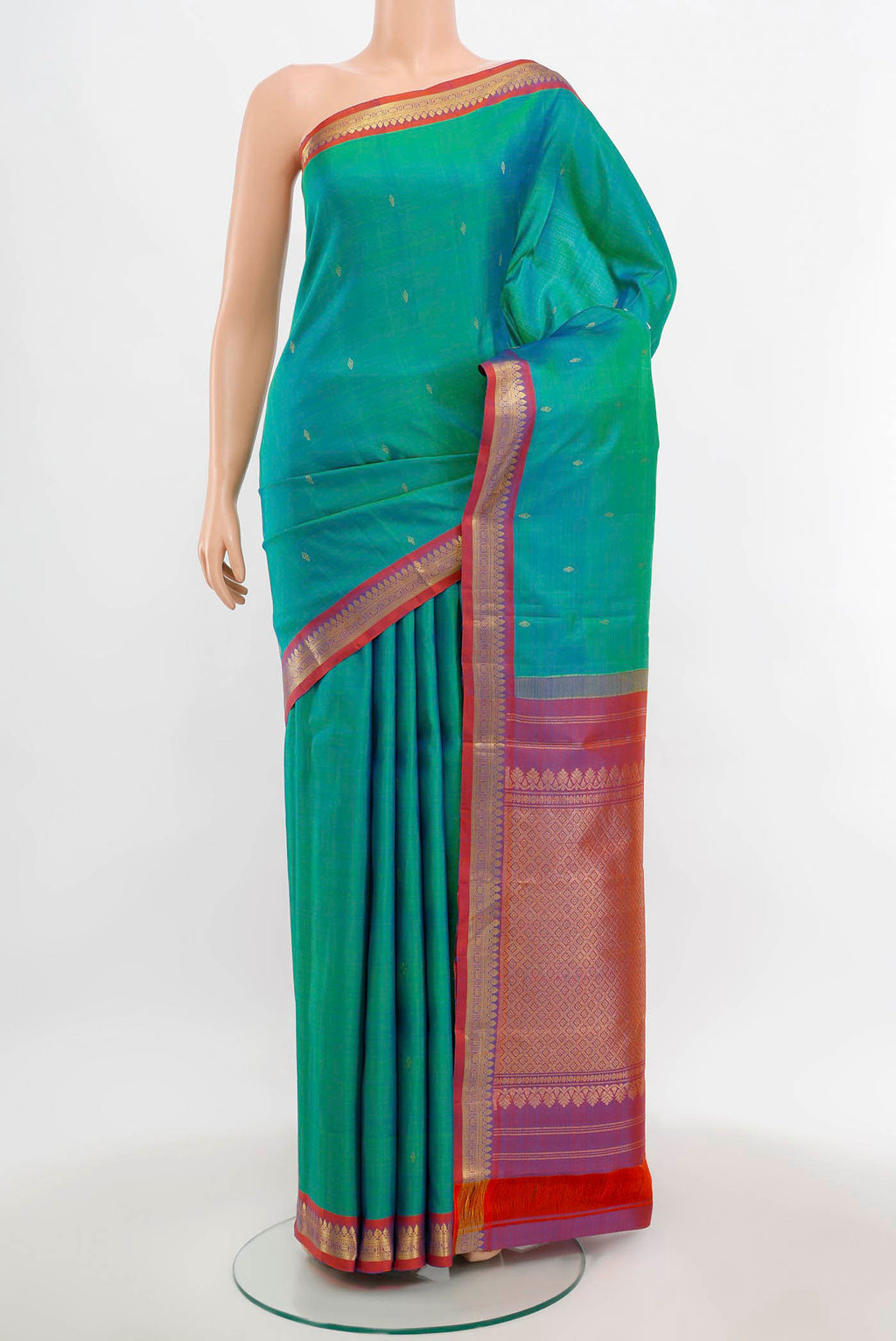 Peacock Blue Kanchipuram Silk Saree with Zari Butta on the body and Silk Border.  displayed on a mannequin