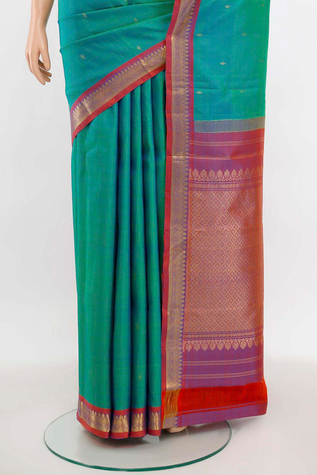 Pleats and pallu of Peacock Blue Kanchipuram Silk Saree with Zari Butta on the body and Silk Border. 