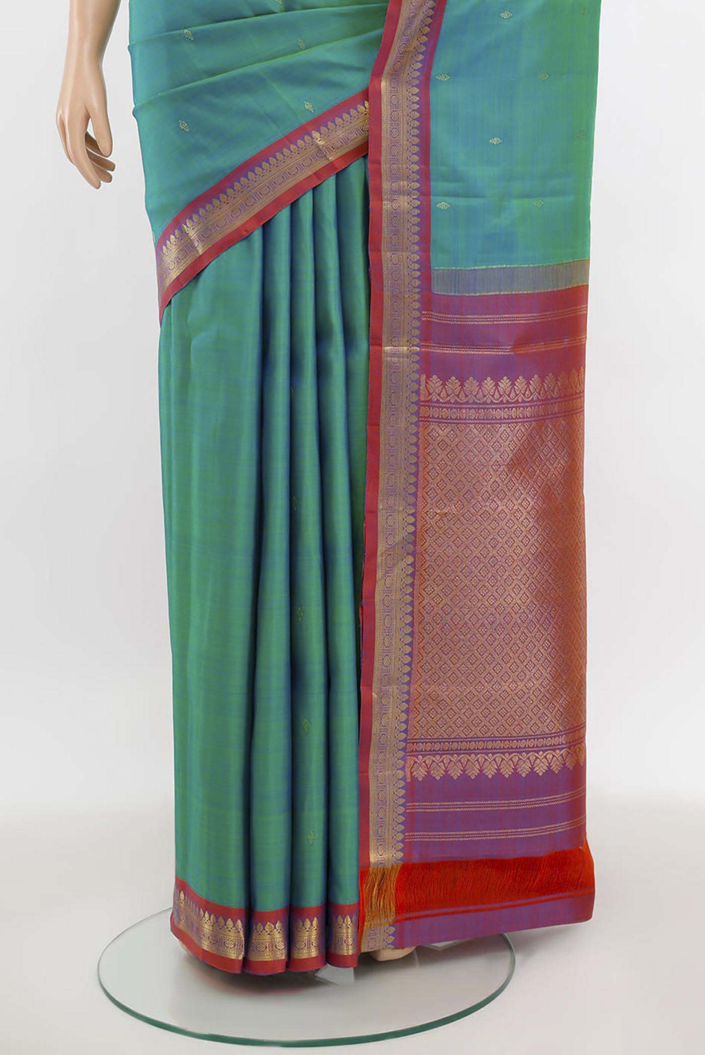 Pleats and pallu of Peacock Blue Kanchipuram Silk Saree with Zari Butta on the body and Silk Border. 