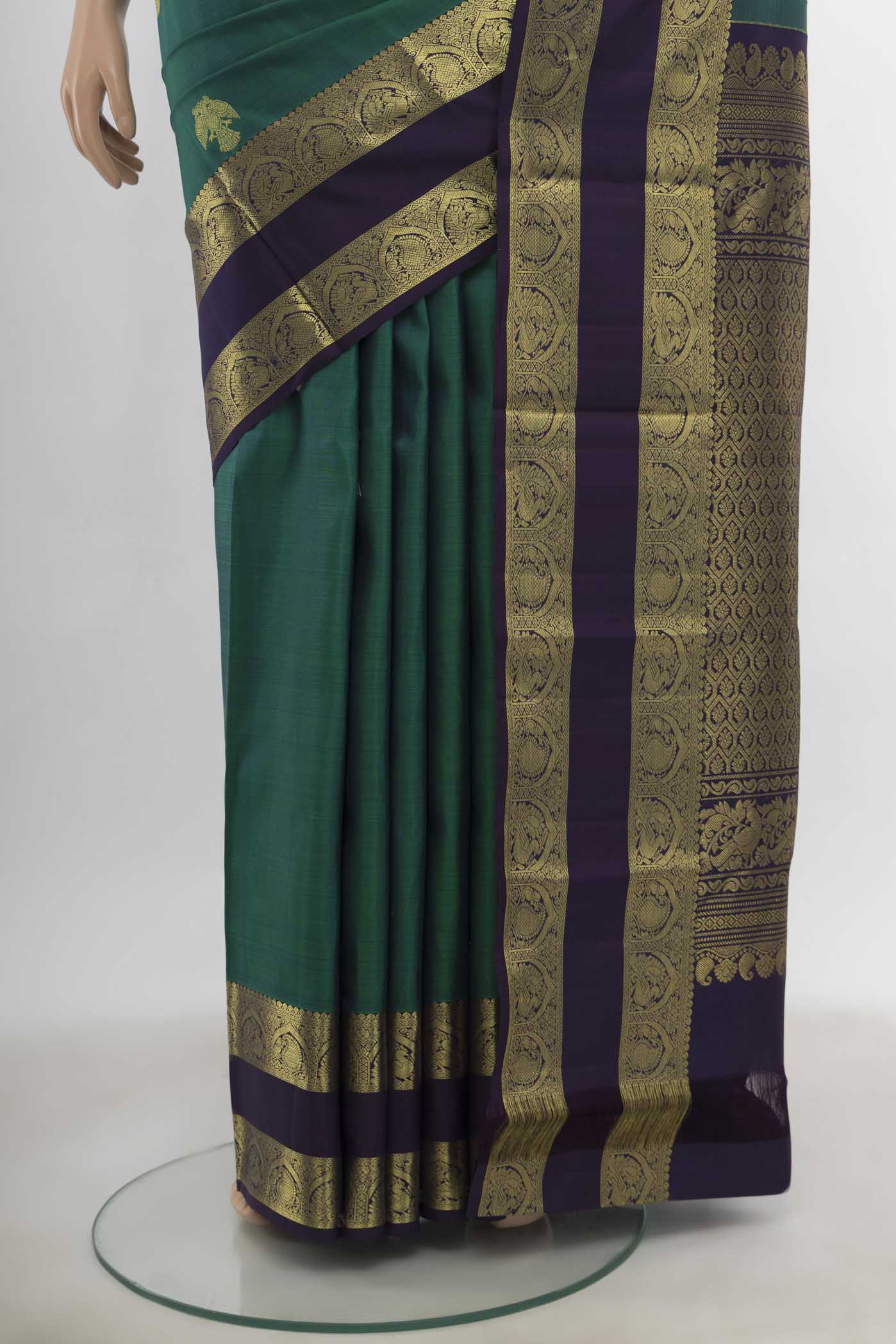 Pleats and pallu of Peacock Blue Kanchipuram Silk Saree with Zari Butta on the body and Silk Border. 