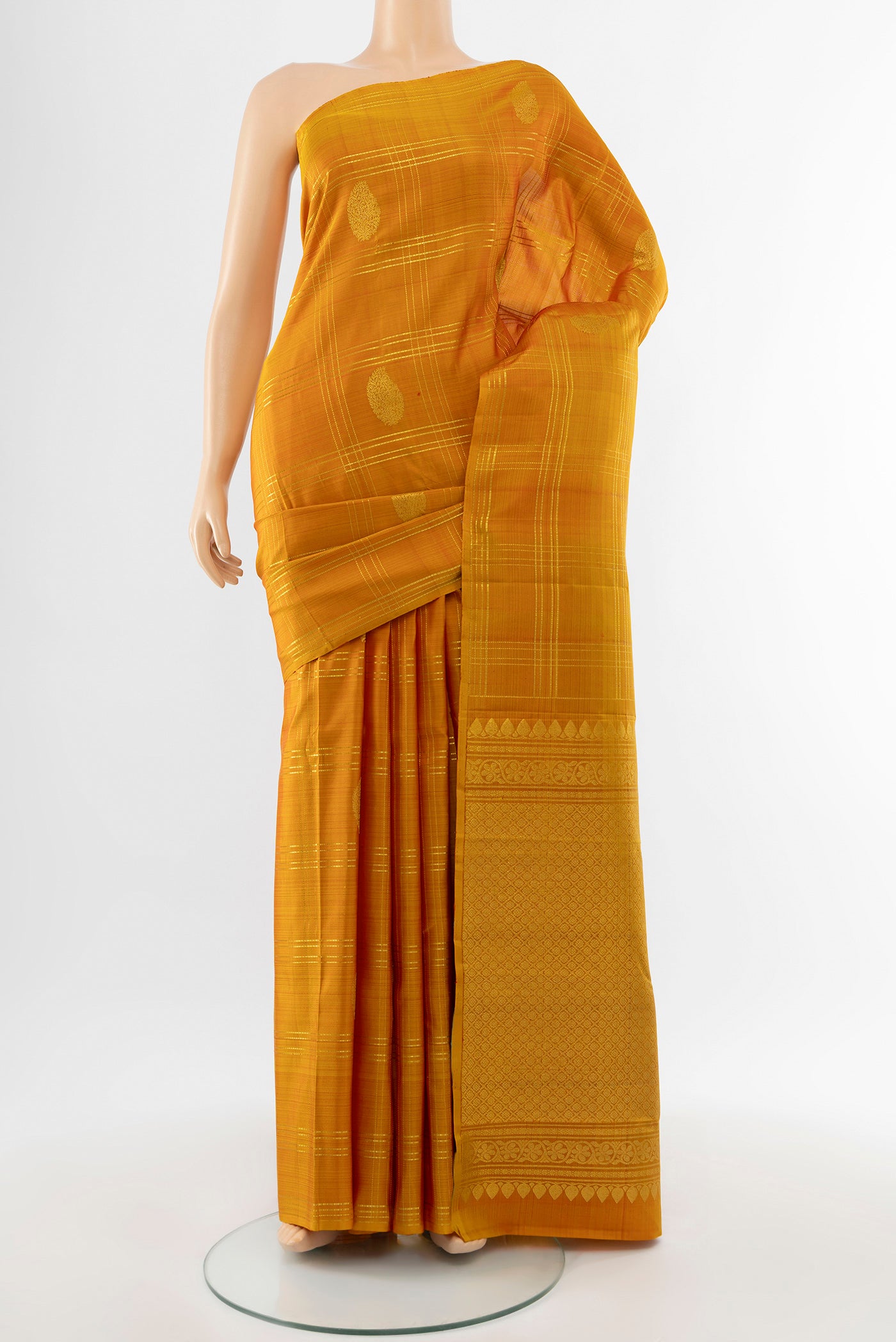 Pure Silk Pure Zari Mustard Kanchipuram Saree with Zari Butta on the body and Silk Border.  displayed on a mannequin