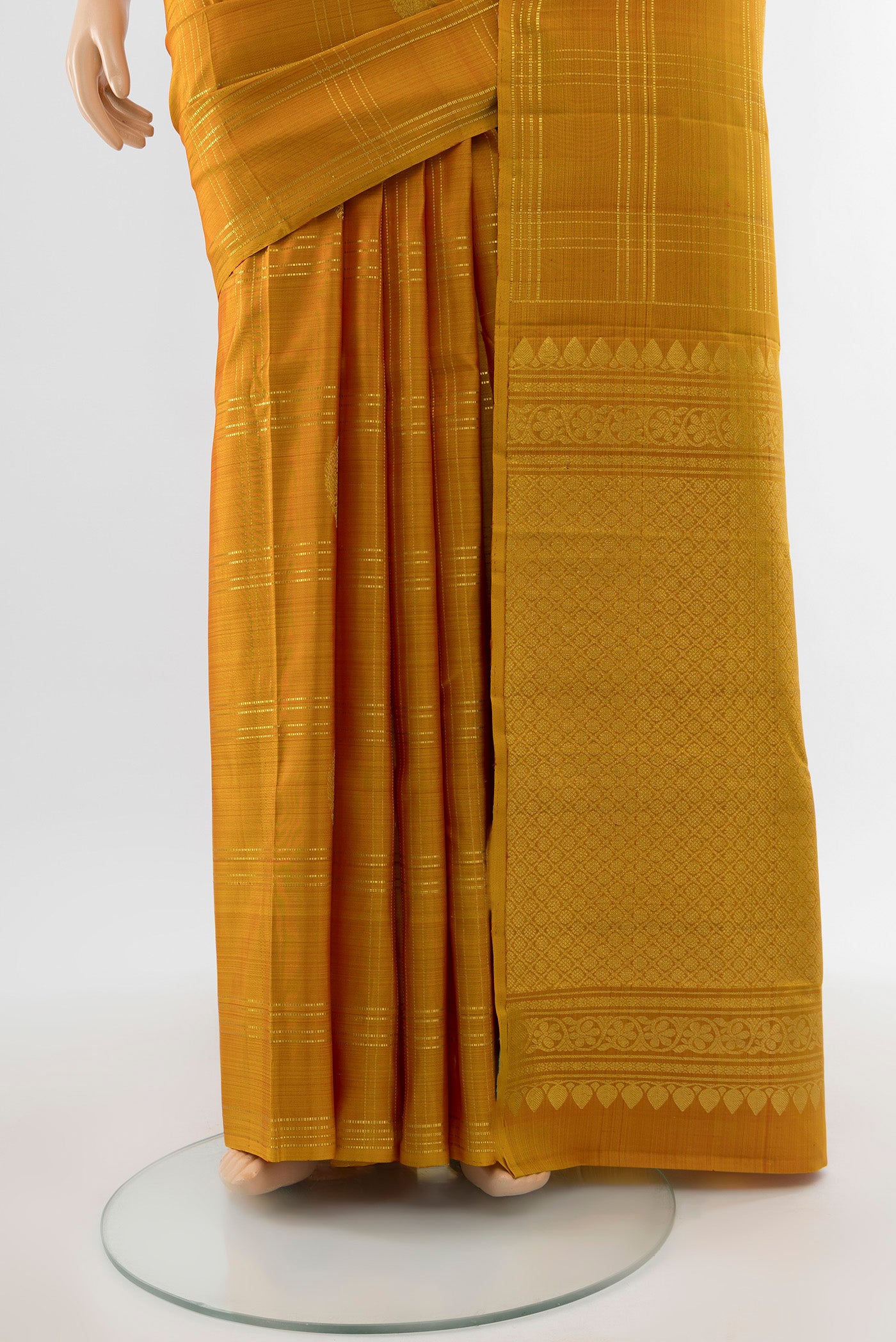 Pleats and pallu of Pure Silk Pure Zari Mustard Kanchipuram Saree with Zari Butta on the body and Silk Border. 