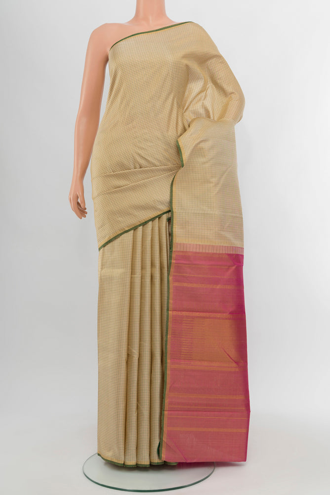 Cream Kanjivaram Silk Saree with Zari Butta on the body and Silk Border.  displayed on a mannequin