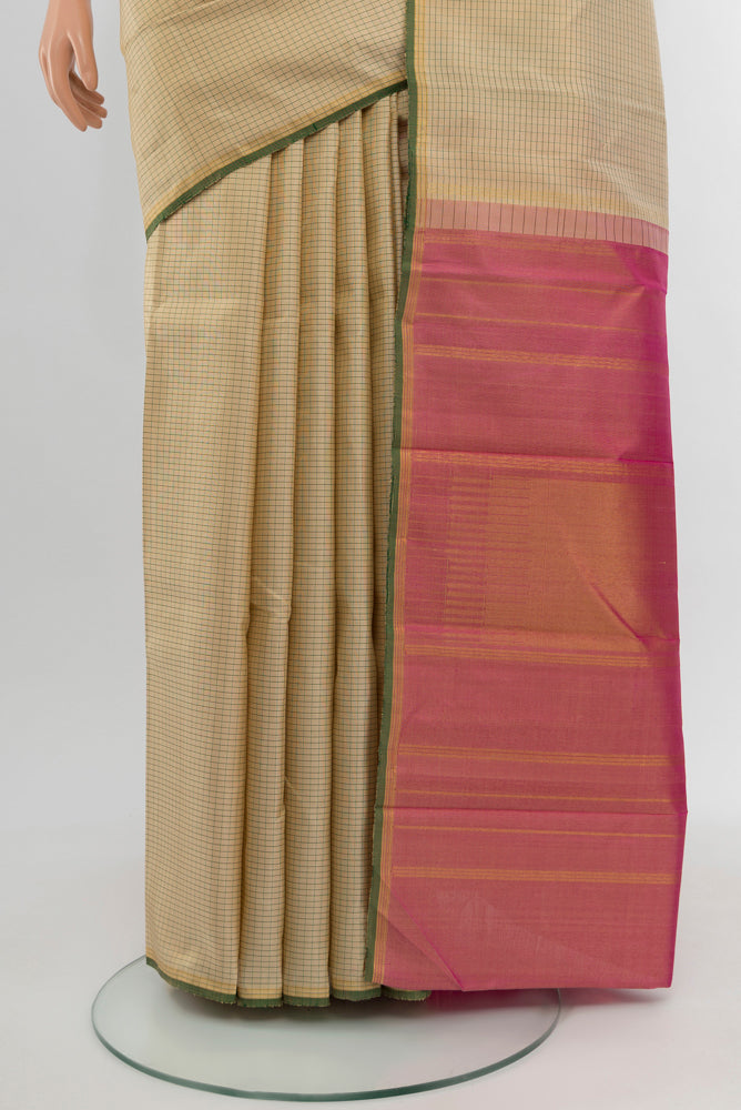 Pleats and pallu of Cream Kanjivaram Silk Saree with Zari Butta on the body and Silk Border. 
