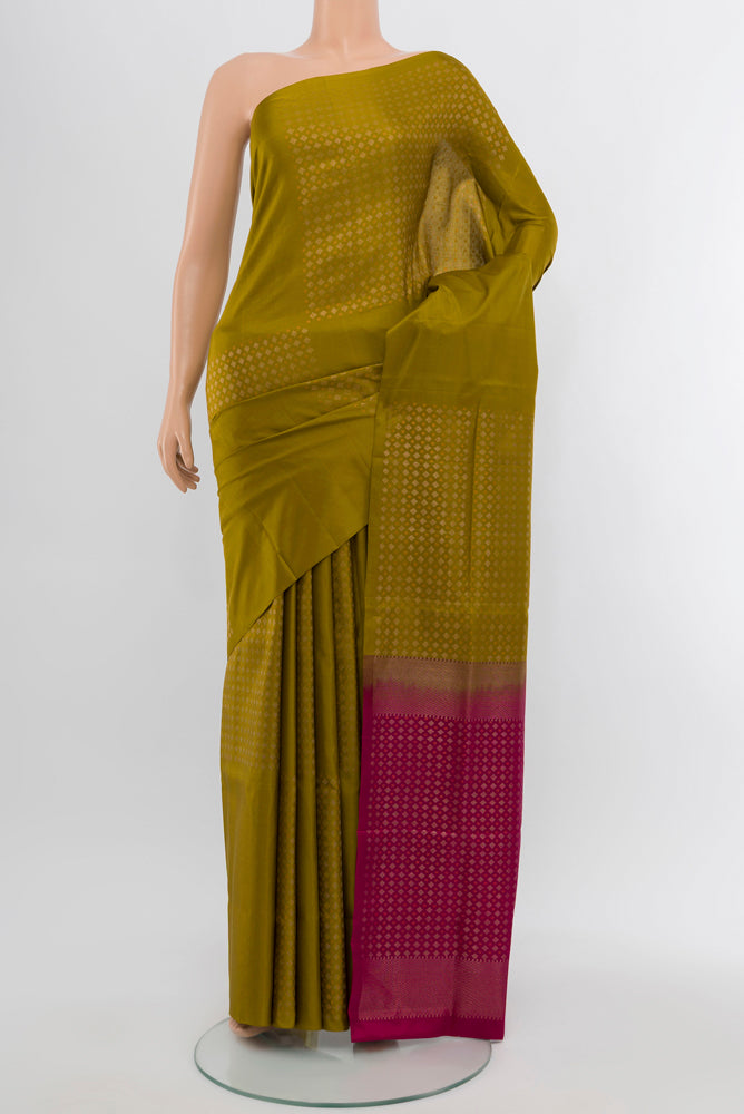 Mehandi Green Soft Silk Saree with Zari Butta on the body and Silk Border.  displayed on a mannequin