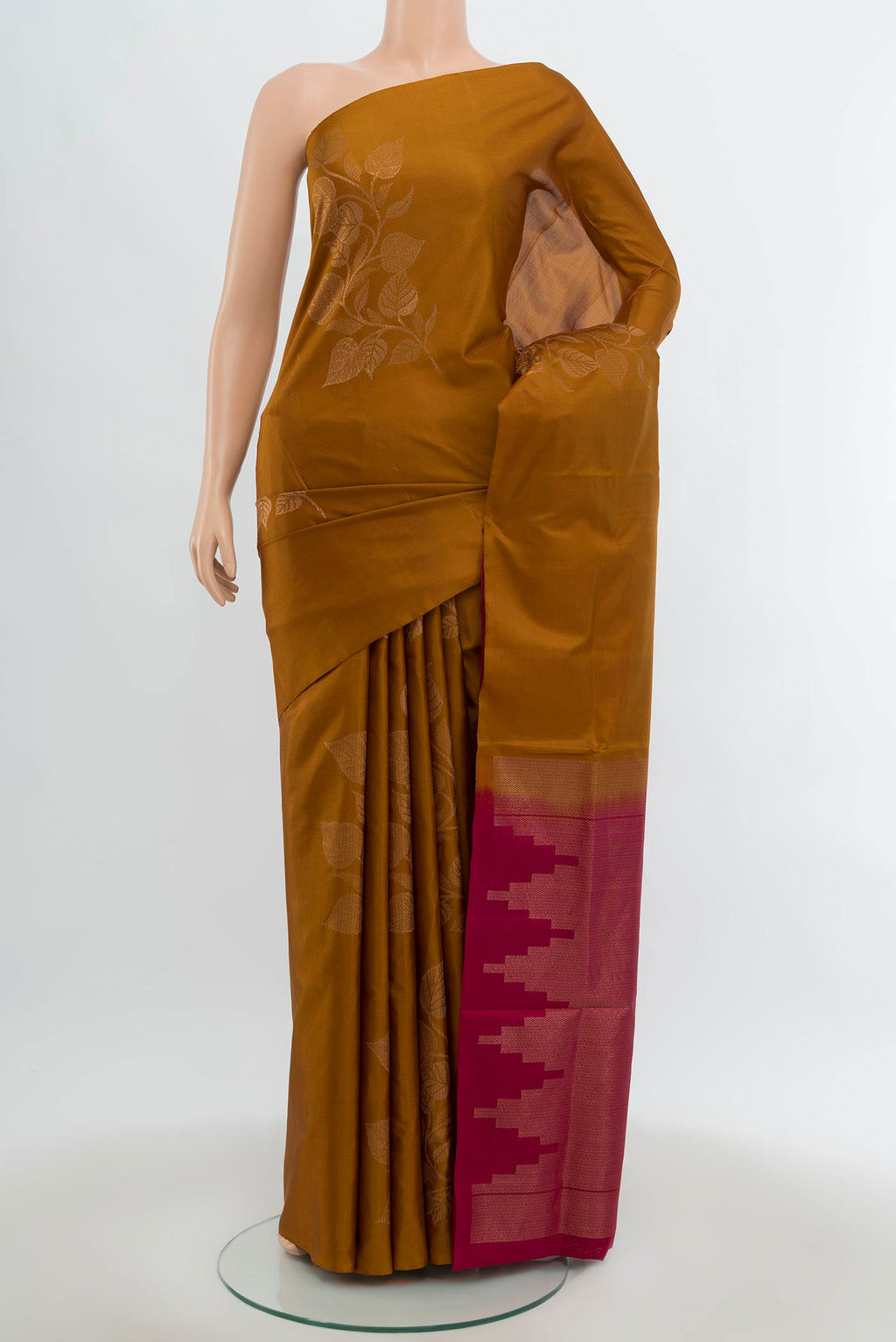 Rust Soft Silk Saree with Zari Butta on the body and Silk Border.  displayed on a mannequin