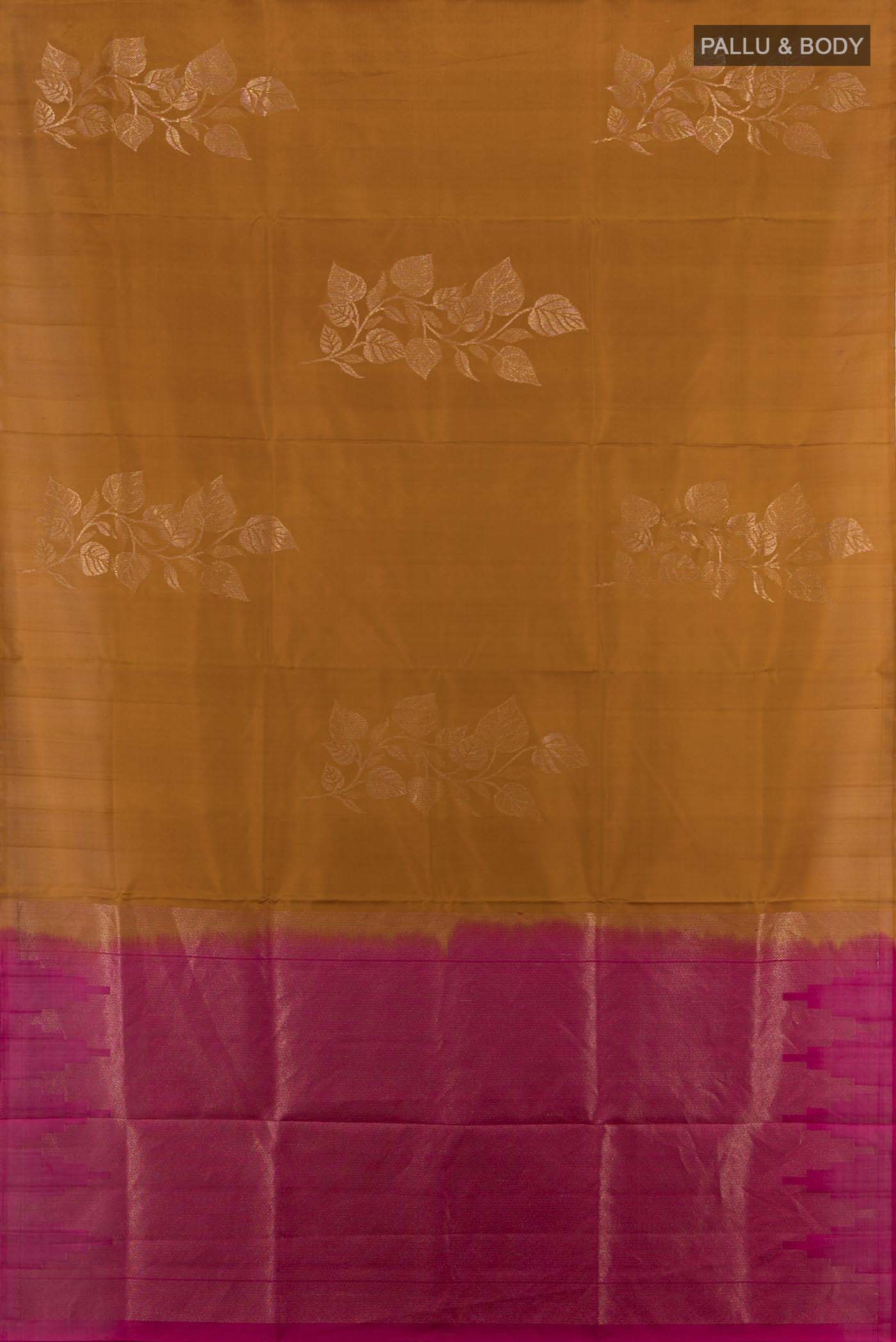 Flat view of Rust Soft Silk Saree with Zari Butta on the body and Silk Border. 