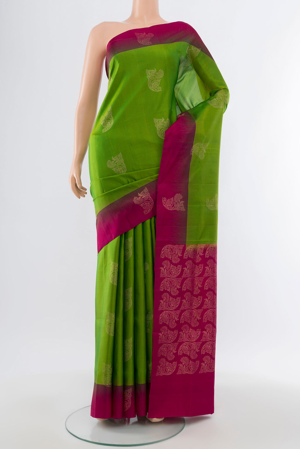 Pure Silk Pure Zari Parrot Green Soft Saree with Zari Butta on the body and Silk Border.  displayed on a mannequin