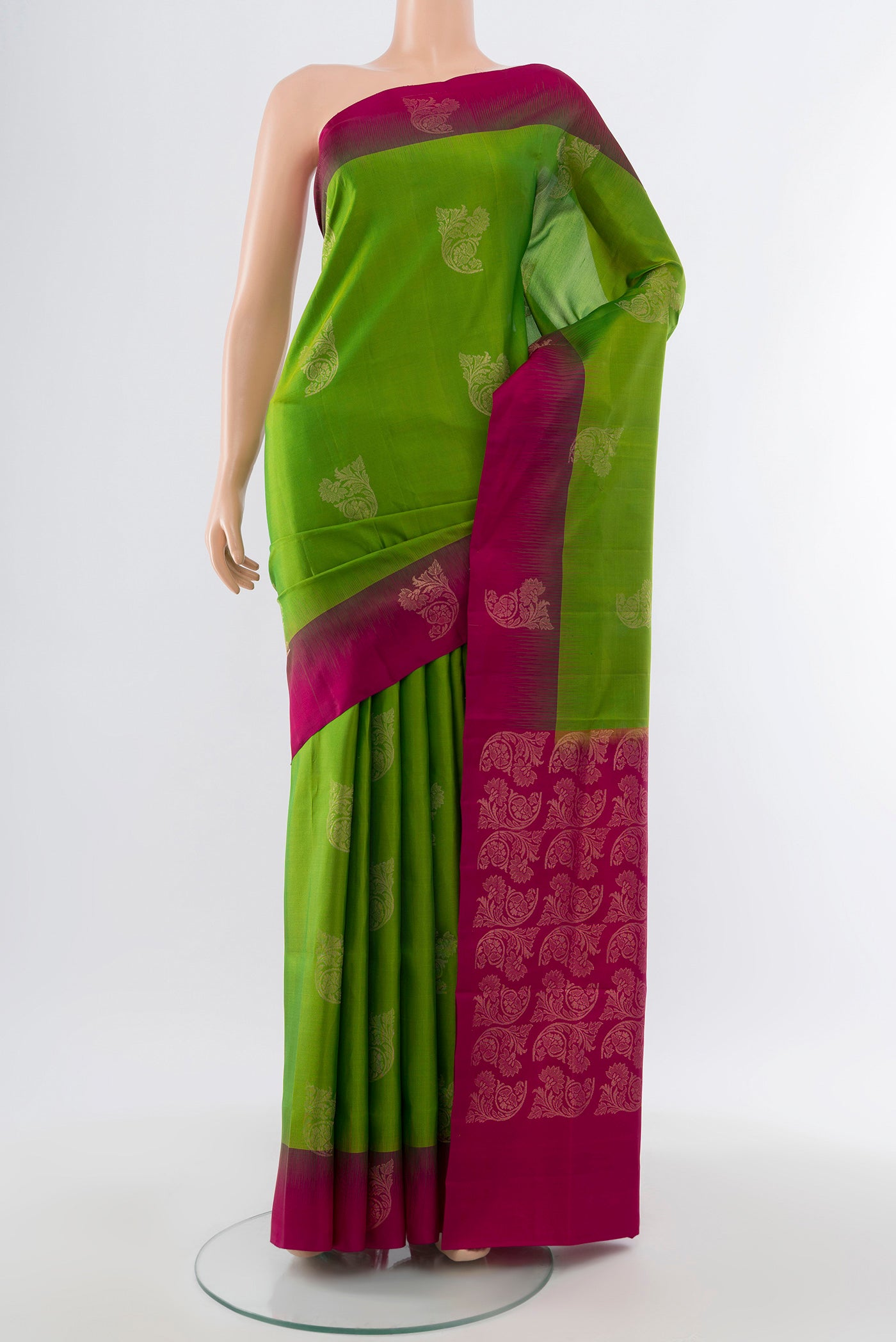 Pure Silk Pure Zari Parrot Green Soft Saree with Zari Butta on the body and Silk Border.  displayed on a mannequin