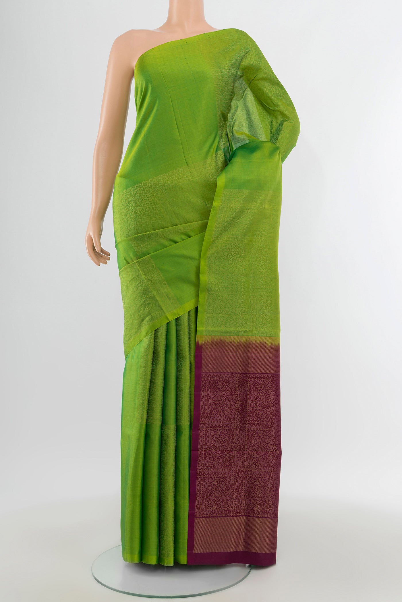 Parrot Green Soft Silk Saree with Zari Butta on the body and Without Border.  displayed on a mannequin