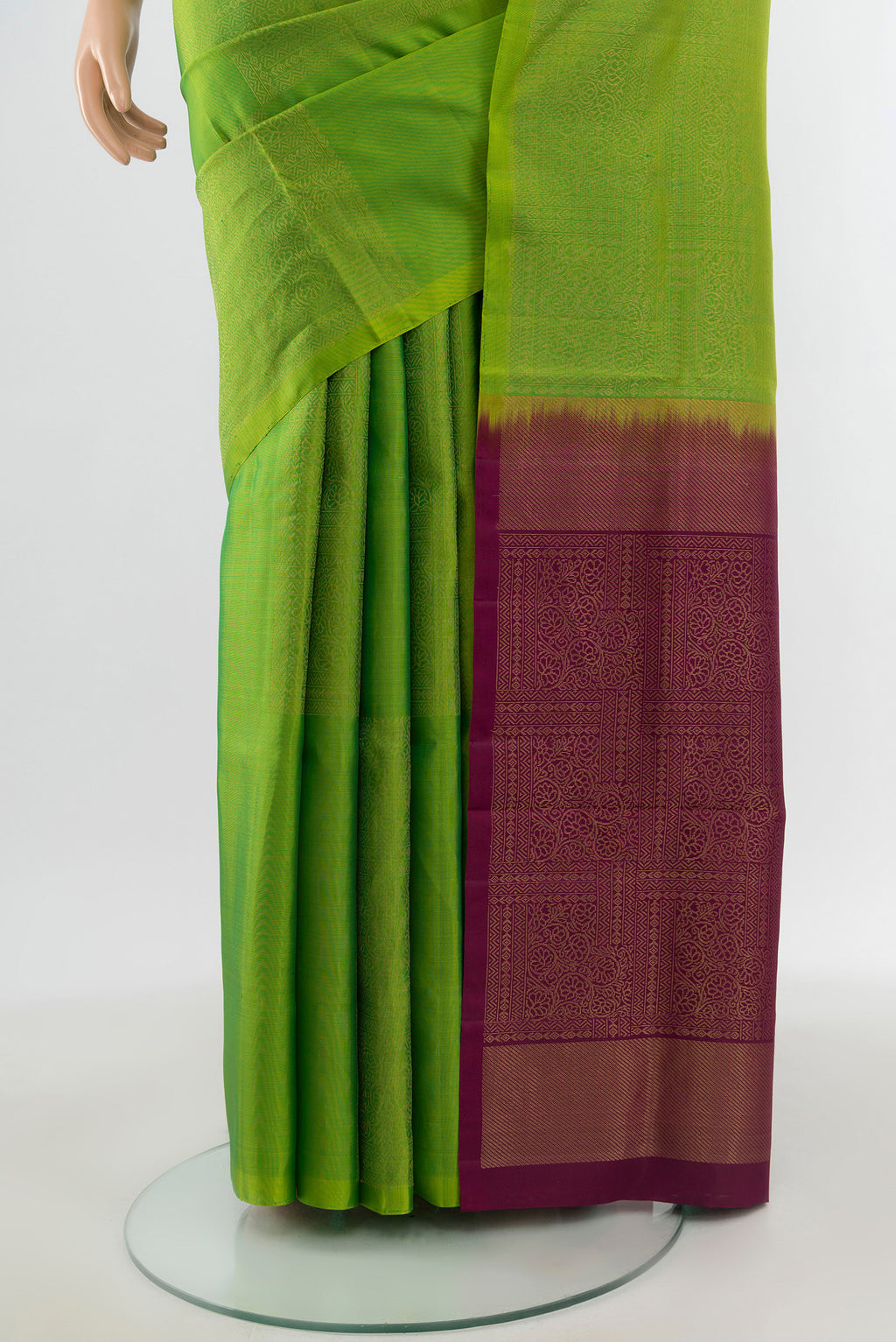 Pleats and pallu of Parrot Green Soft Silk Saree with Zari Butta on the body and Without Border. 
