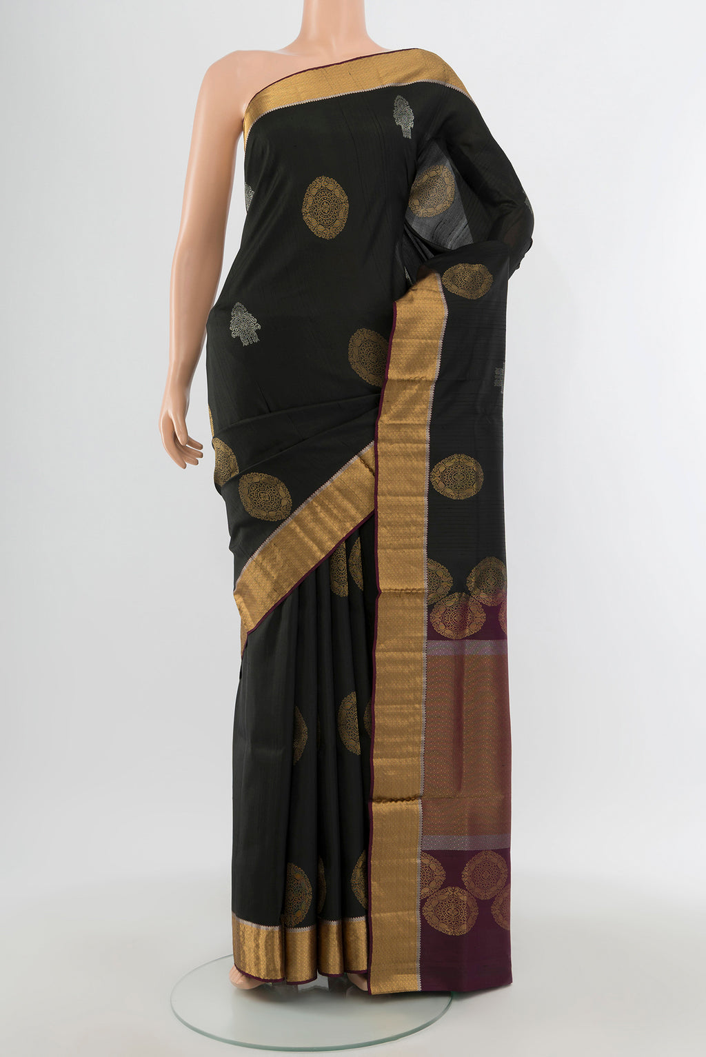 Black Soft Silk Saree with Zari Butta on the body and Zari Border.  displayed on a mannequin