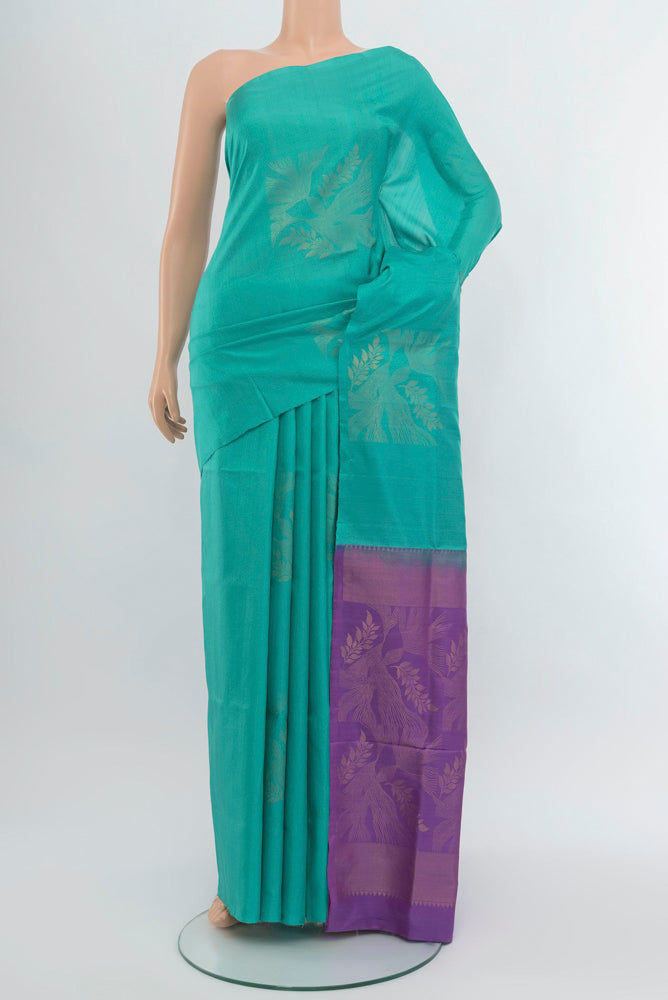 Sky Blue Soft Silk Saree with Zari Butta on the body and Zari Border.  displayed on a mannequin