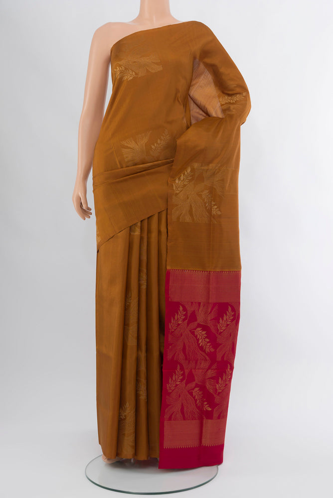 Brown Soft Silk Saree with Zari Butta on the body and Silk Border.  displayed on a mannequin