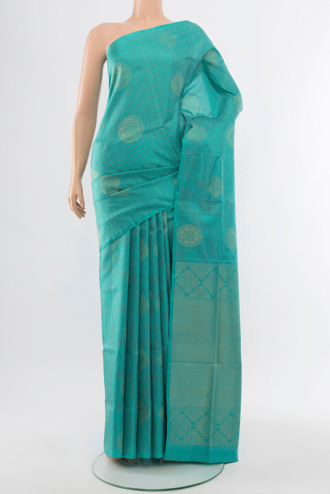 Sky Blue Soft Silk Saree with Zari Butta on the body and Silk Border.  displayed on a mannequin