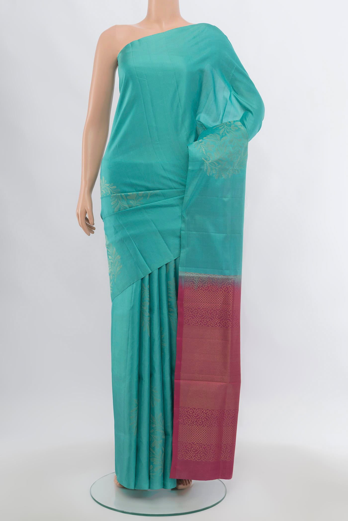 Sea Green Soft Silk Saree with Zari Butta on the body and Zari Border.  displayed on a mannequin