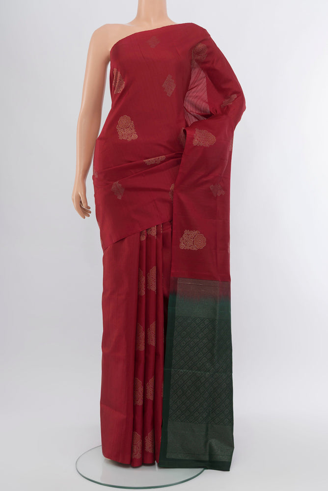 Maroon Soft Silk Saree with Zari Butta on the body and Silk Border.  displayed on a mannequin