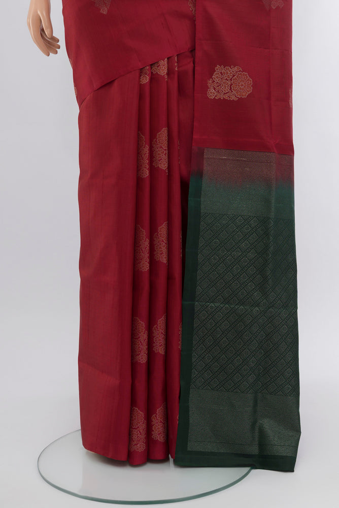Pleats and pallu of Maroon Soft Silk Saree with Zari Butta on the body and Silk Border. 