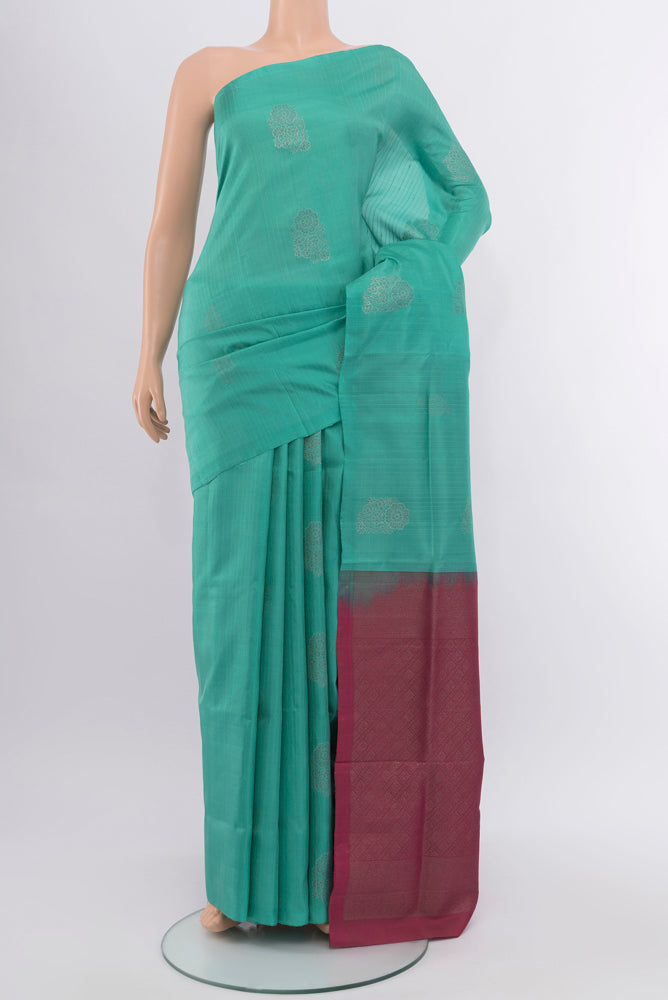 Sky Blue Soft Silk Saree with Zari Butta on the body and Silk Border.  displayed on a mannequin