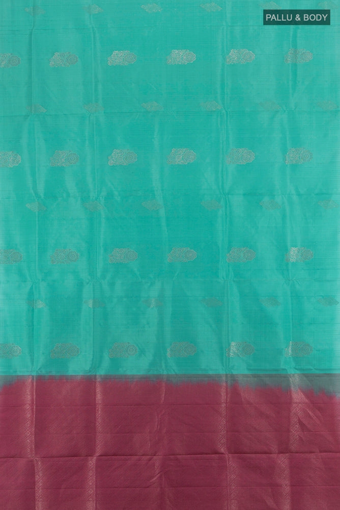 Flat view of Sky Blue Soft Silk Saree with Zari Butta on the body and Silk Border. 