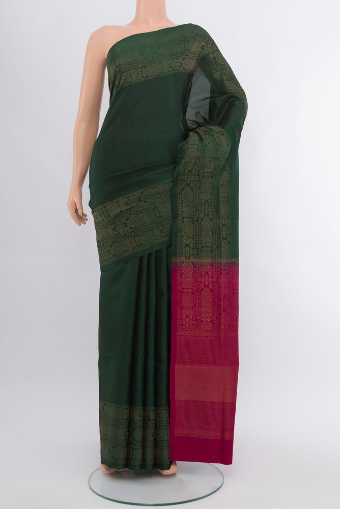 Mint Green Soft Silk Saree with Zari Butta on the body and Silk Border.  displayed on a mannequin