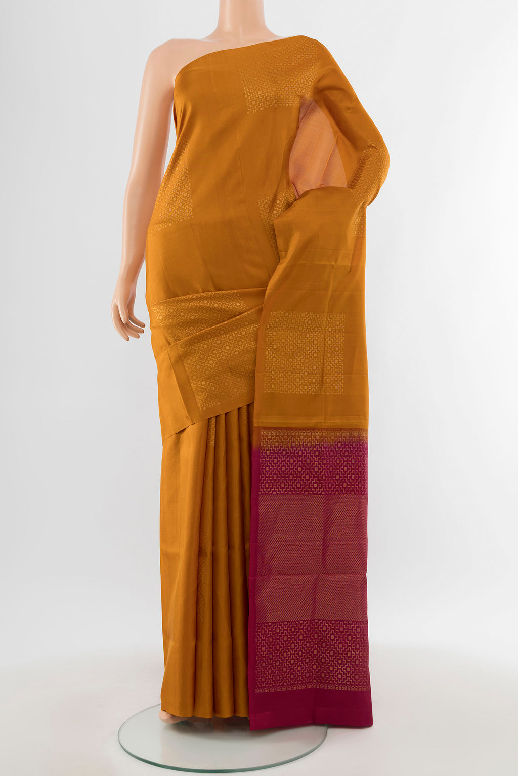 Pure Silk Pure Zari Brown Soft Saree with Zari Butta on the body and Silk Border.  displayed on a mannequin
