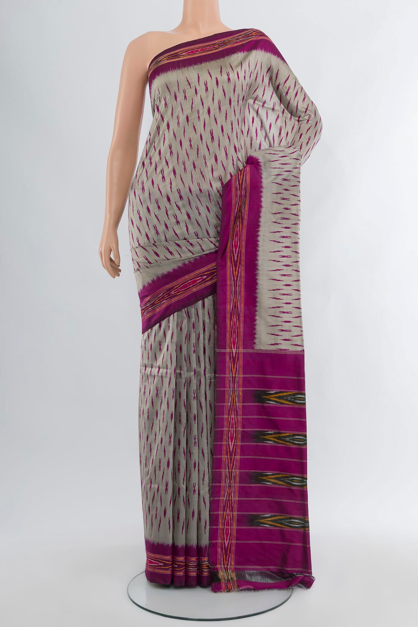 Grey Pochampally Silk Saree with Ikat design on the body and Ikat Border.  displayed on a mannequin