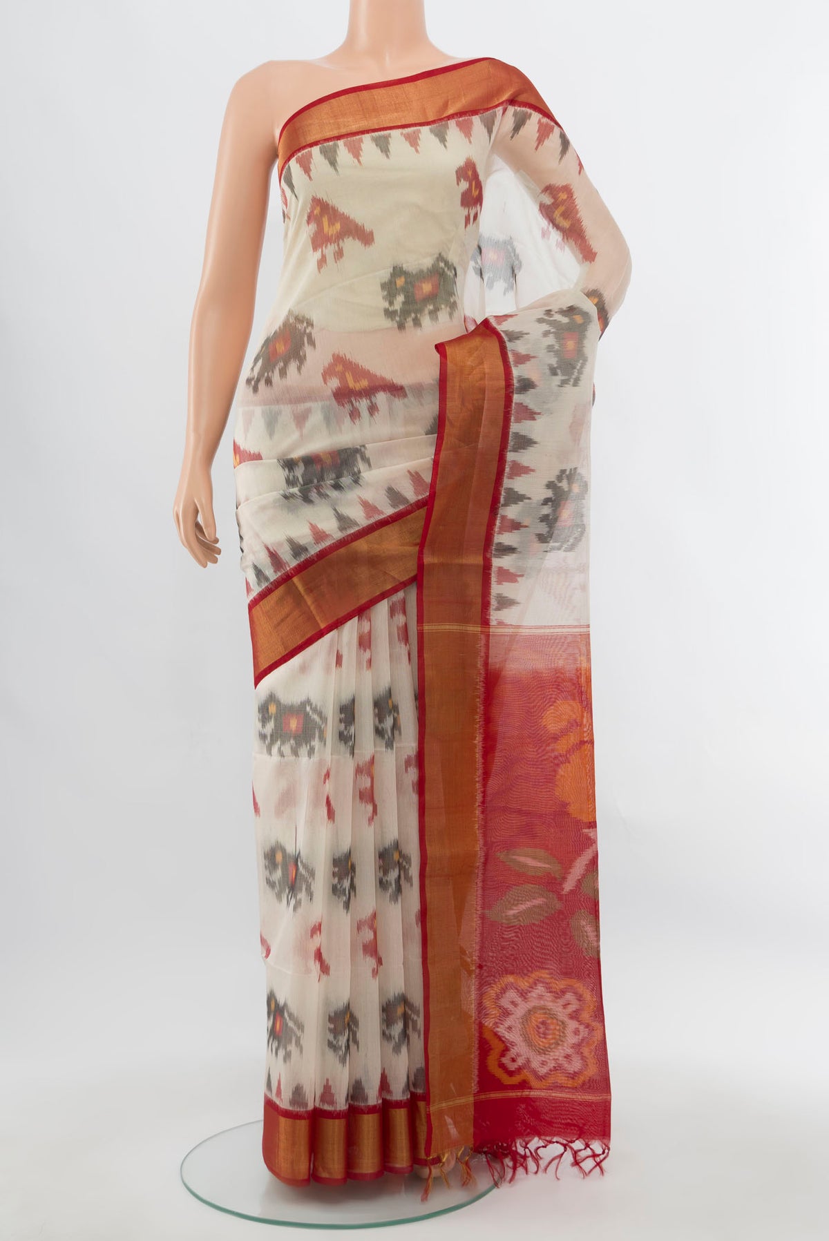 Cream Maheshwari Silk Cotton Saree with Ikat Print on the body and Silk Border.  displayed on a mannequin