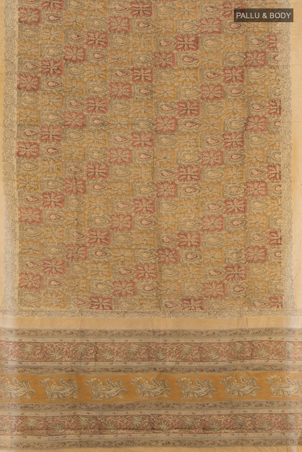 Flat view of Beige Tussar Silk Saree with kalamkari Print on the body and Zari Border. 