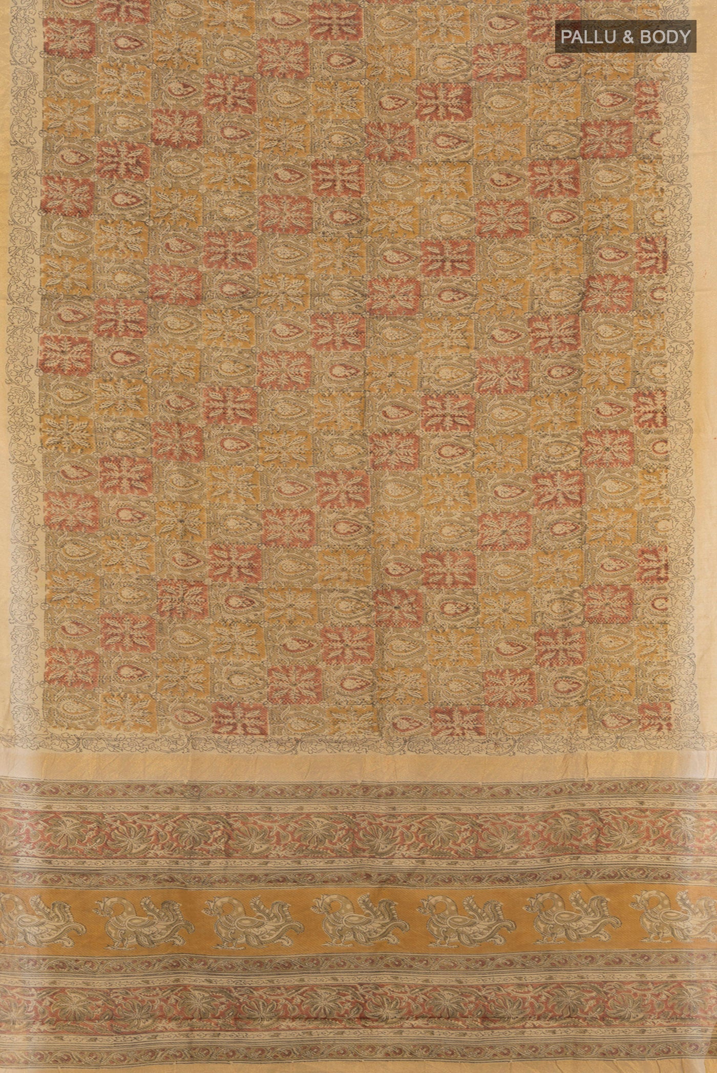 Flat view of Beige Tussar Silk Saree with kalamkari Print on the body and Zari Border. 