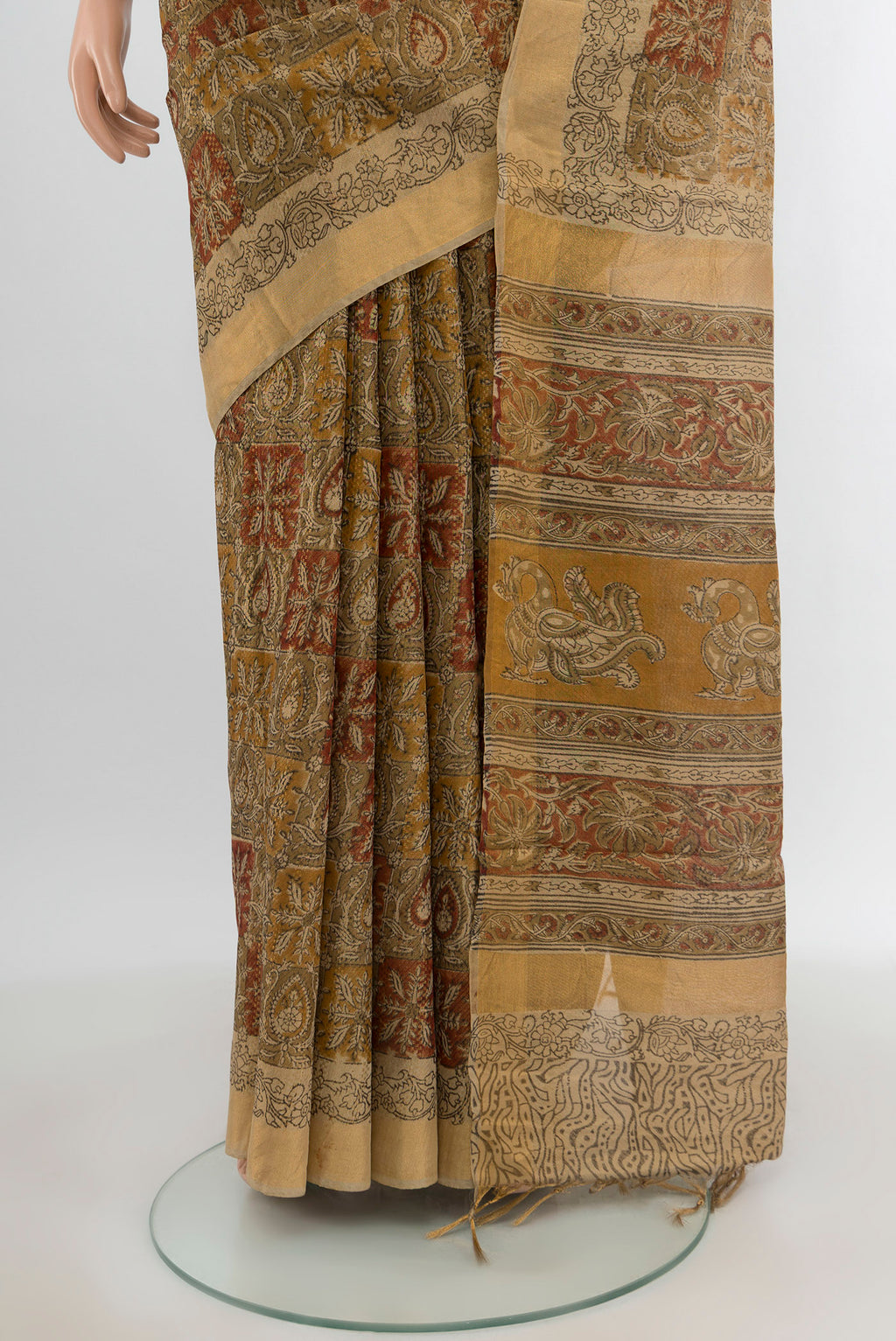 Pleats and pallu of Beige Tussar Silk Saree with kalamkari Print on the body and Zari Border. 