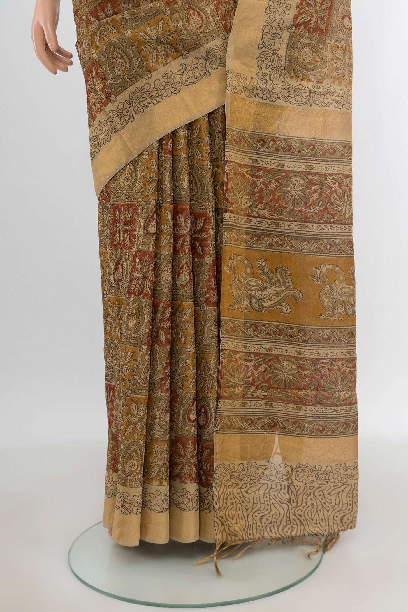 Pleats and pallu of Beige Tussar Silk Saree with kalamkari Print on the body and Zari Border. 