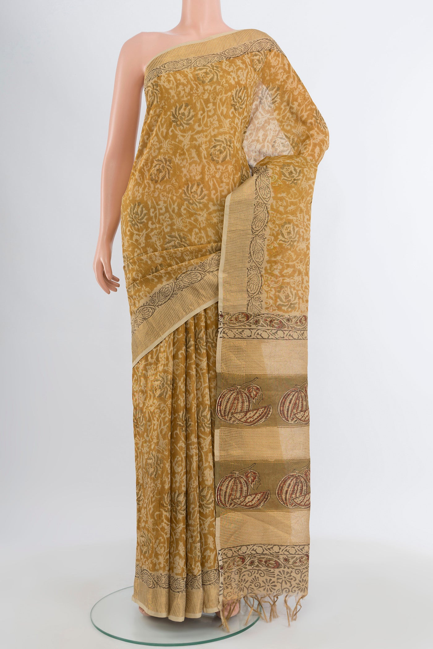 Mustard Tussar Silk Saree with kalamkari Print on the body and Zari Border.  displayed on a mannequin