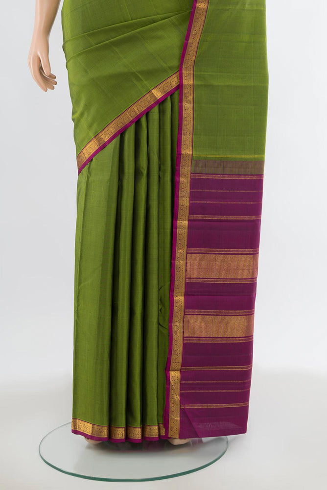 Pleats and pallu of Green Kanjivaram Silk Saree with Zari Butta on the body and Silk Border. 