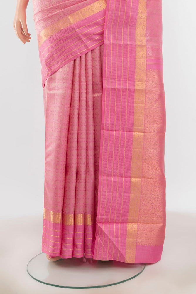 Pleats and pallu of Rose pink Kanchipuram Silk Saree with Zari Butta on the body and Silk Border. 