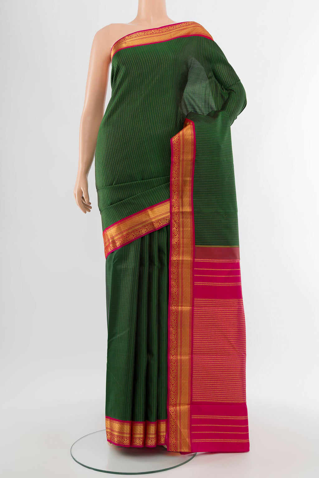Pure Silk Pure Zari Bottle Green Kanjivaram Saree with Zari Butta on the body and Silk Border.  displayed on a mannequin