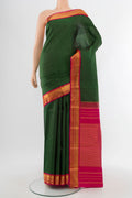 Pure Silk Pure Zari Bottle Green Kanjivaram Saree with Zari Butta on the body and Silk Border.  displayed on a mannequin