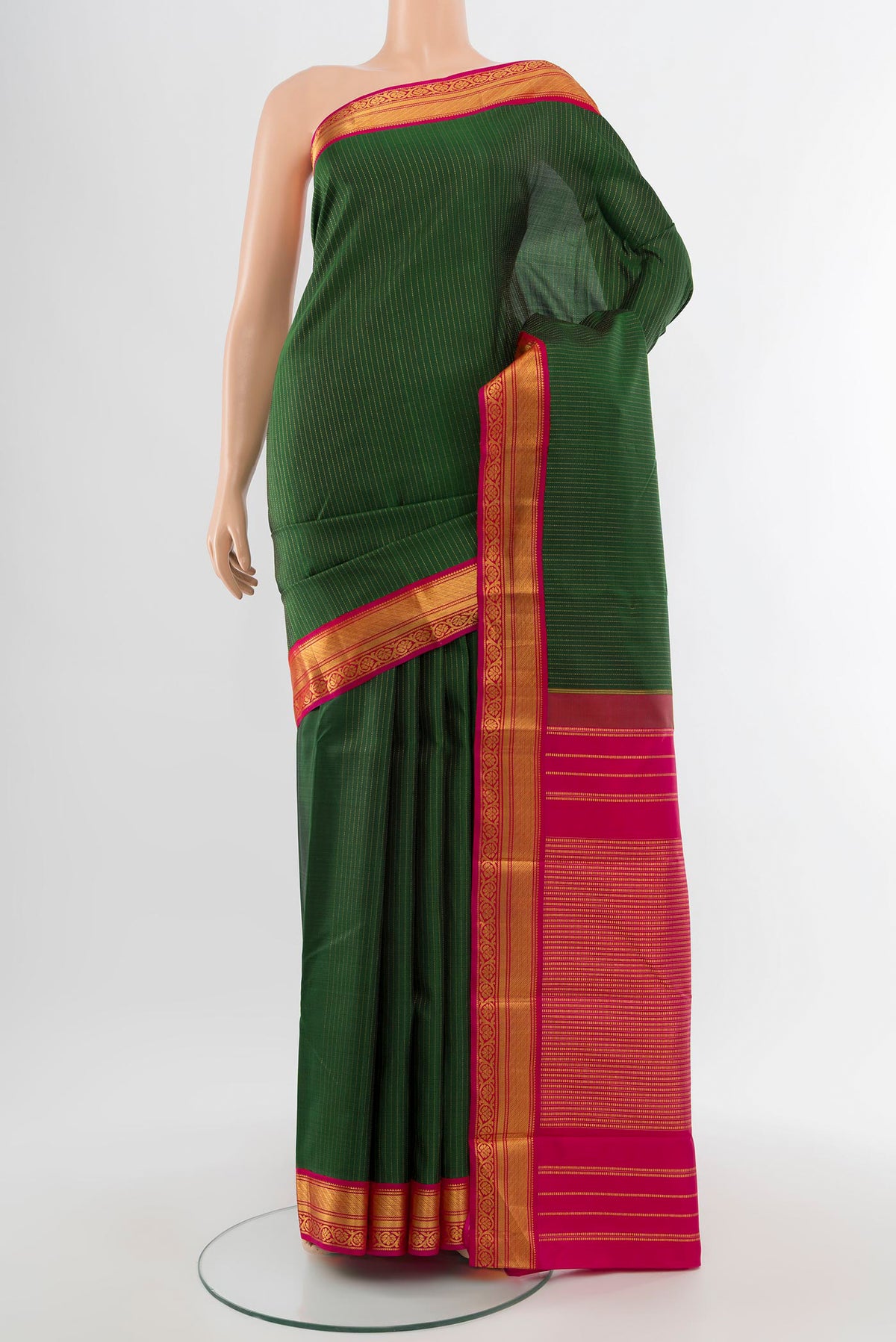 Pure Silk Pure Zari Bottle Green Kanjivaram Saree with Zari Butta on the body and Silk Border.  displayed on a mannequin