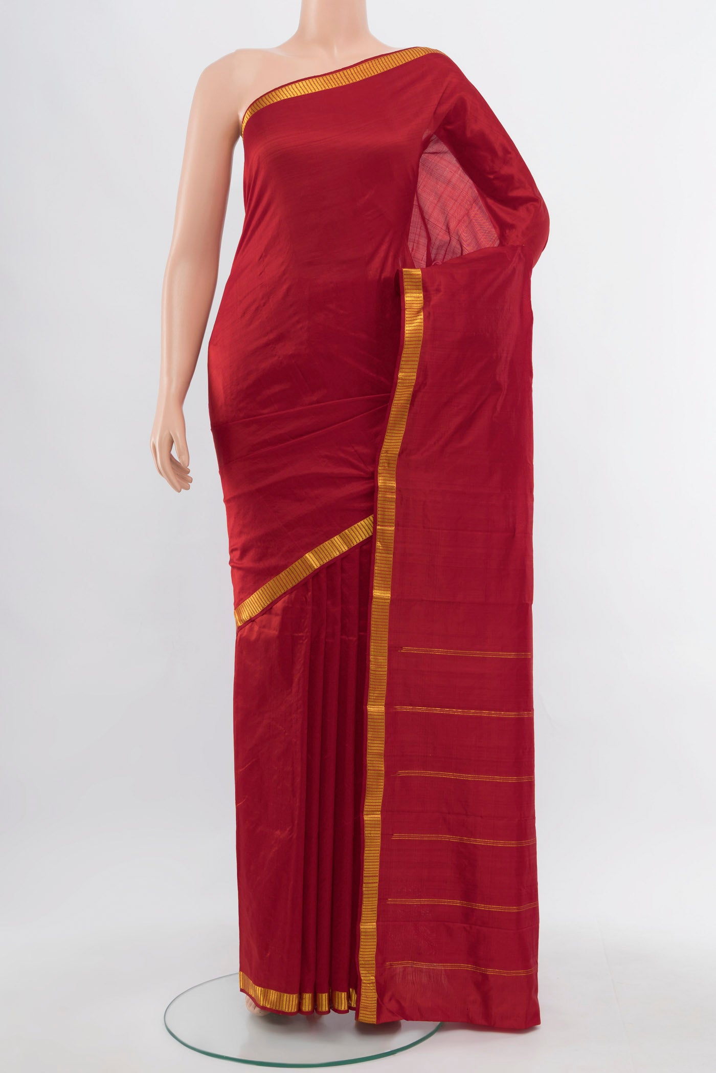 Red Kanchipuram Silk Saree with Zari Butta on the body and Silk Border.  displayed on a mannequin