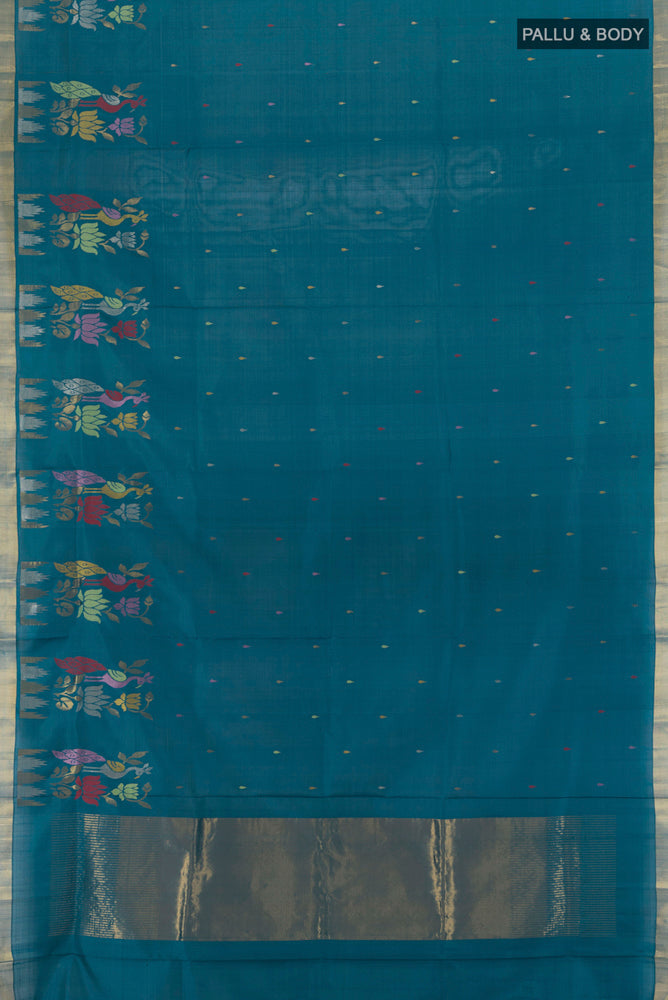 Flat view of Peacock Blue Uppada Silk Saree with Zari Butta on the body and Silk Border. 