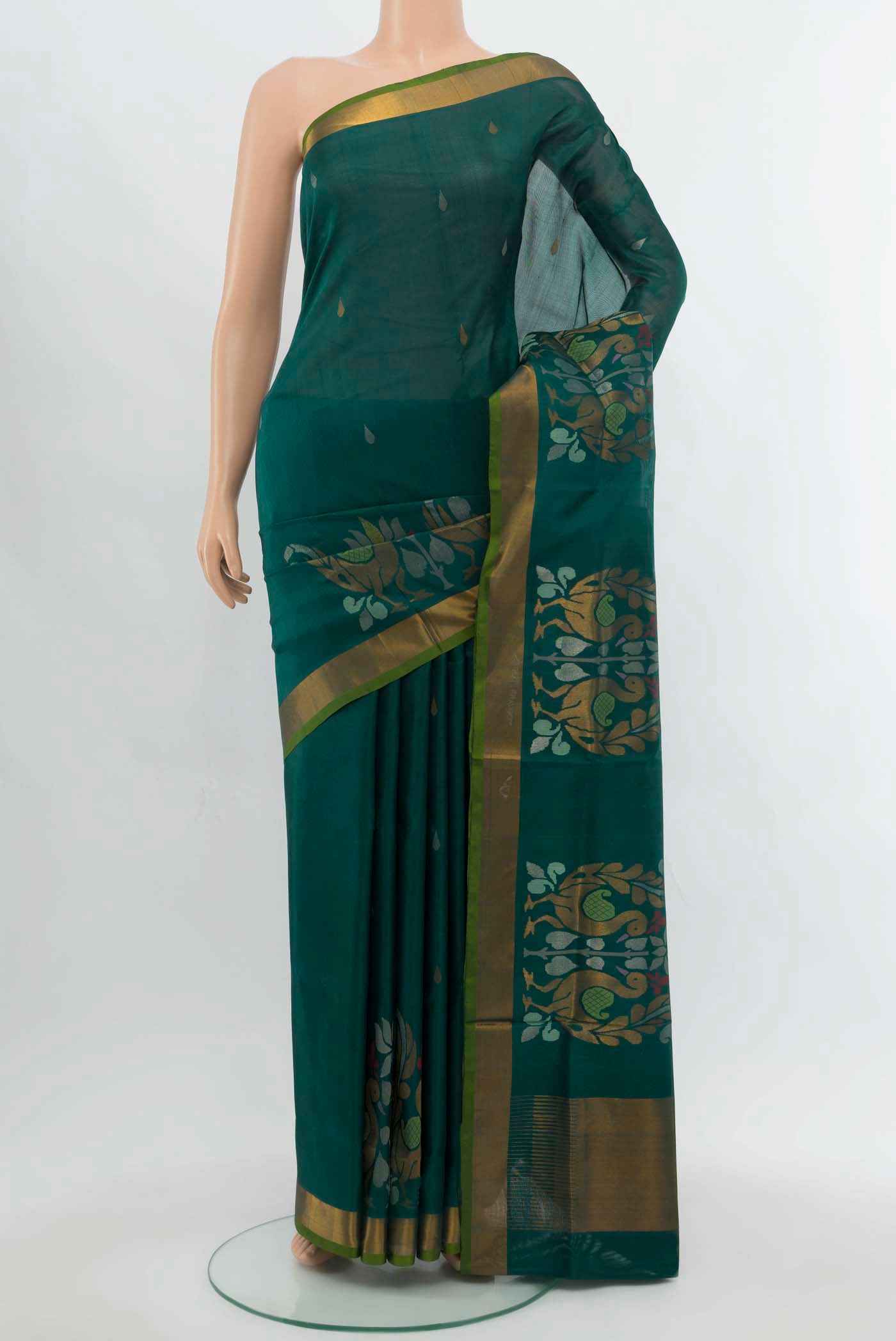 Peacock Blue Uppada Silk Saree with Zari Butta on the body and Silk Border.  displayed on a mannequin