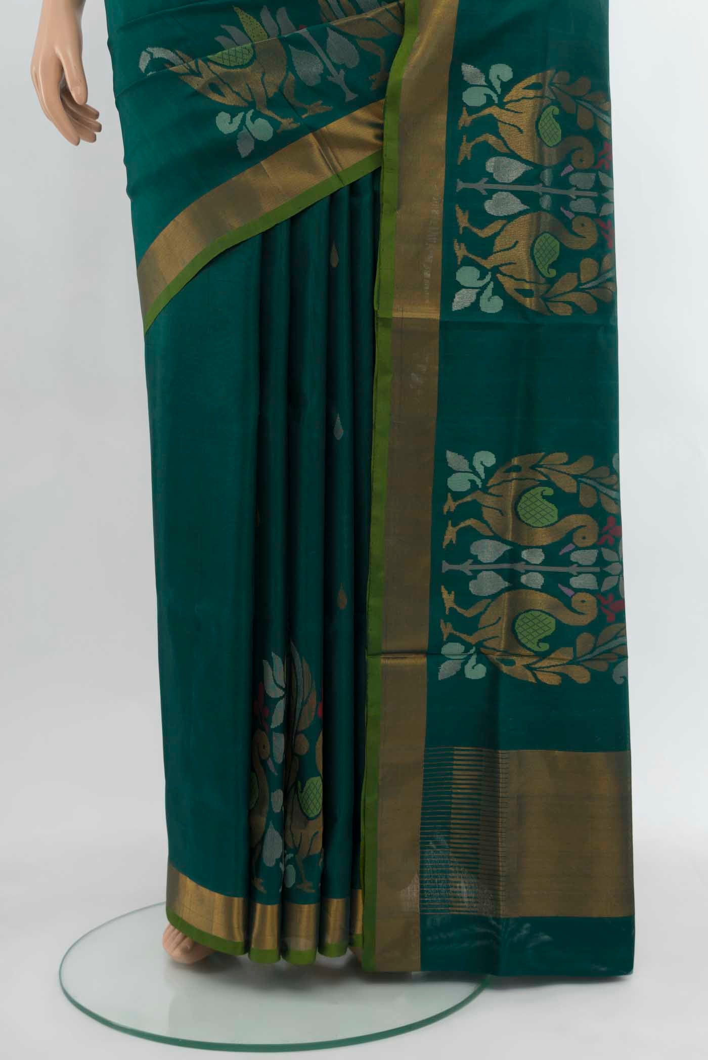 Pleats and pallu of Peacock Blue Uppada Silk Saree with Zari Butta on the body and Silk Border. 