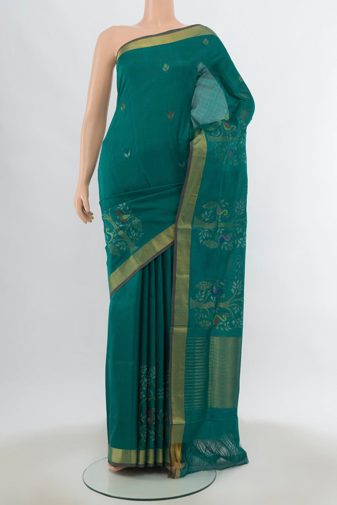 Peacock Blue Uppada Silk Saree with Zari Butta on the body and Silk Border.  displayed on a mannequin